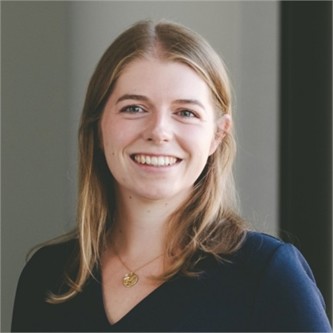Claire O'Reilly in a dark top, in front of a grey background