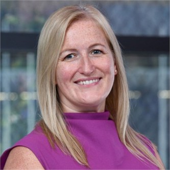 Rachel Armstrong in a pink top, in front of a window